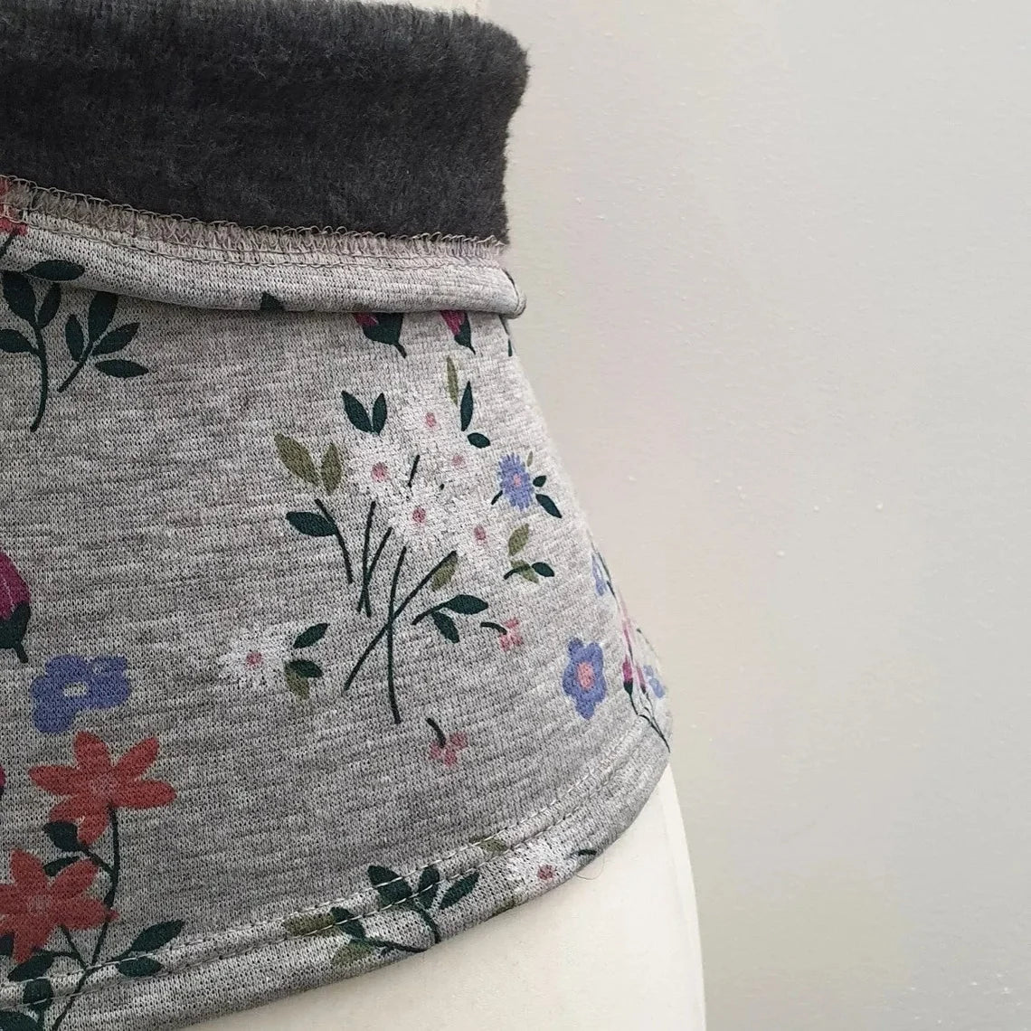 Gray fleece back warmer with a floral print by Fly and Fit