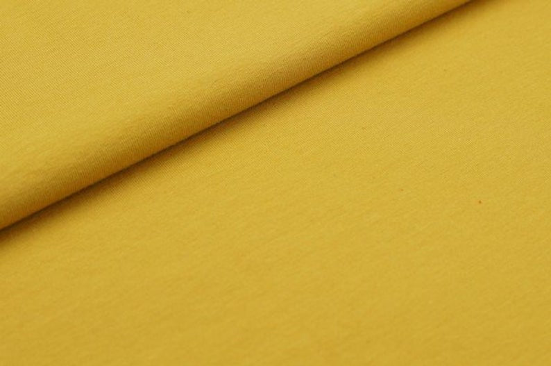 Close-up of yellow fabric with a slight texture