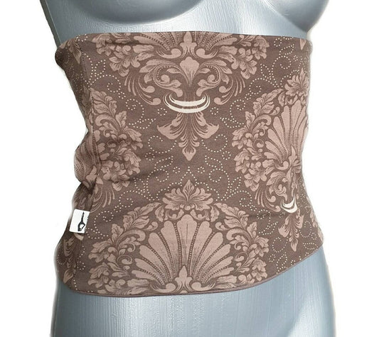Fly and Fit reversible cotton jersey back warmer in mocha brown with an elegant ornament print on a mannequin torso.