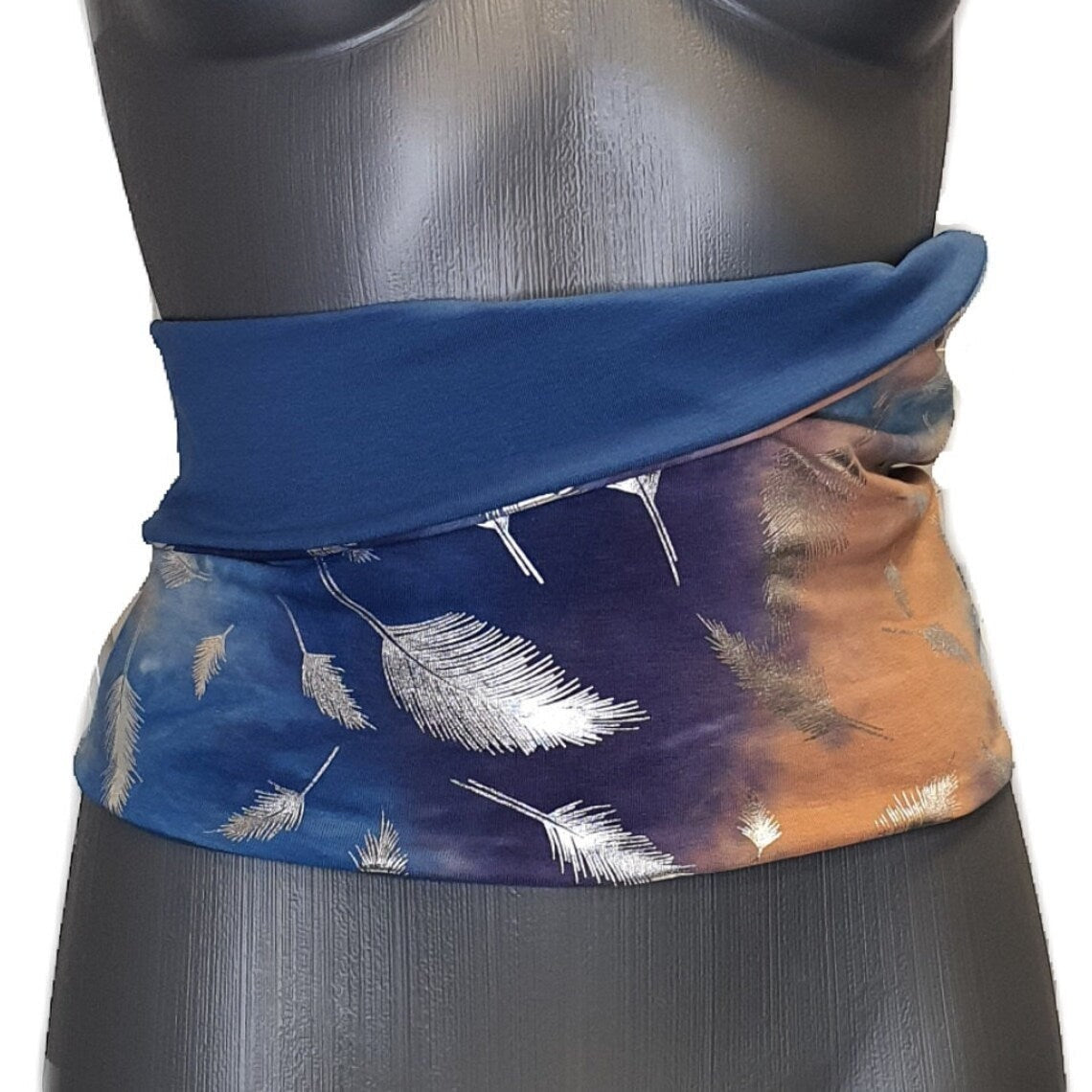 Fly and Fit reversible cotton jersey back warmer featuring blue tie-dye with silver feathers and solid blue side.