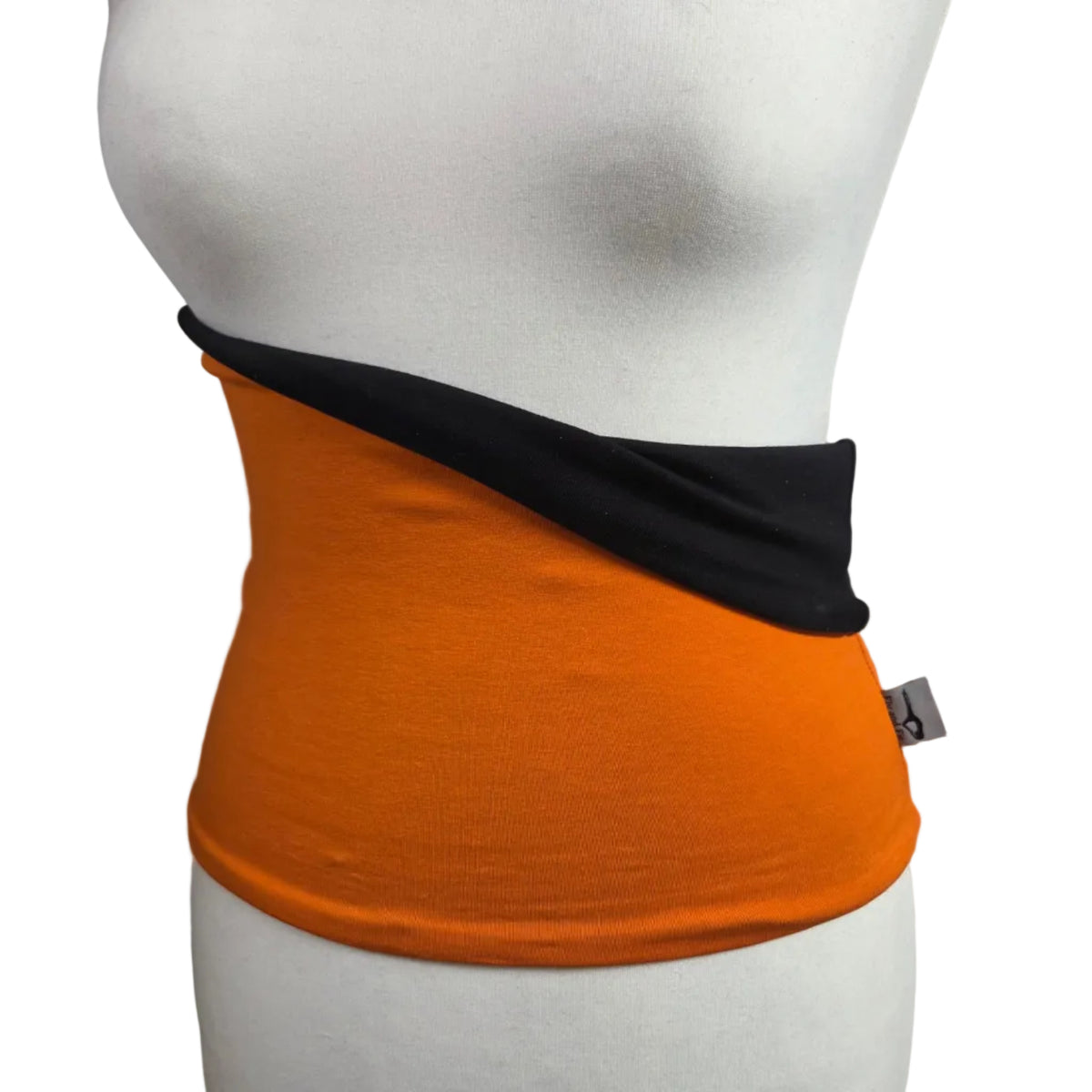An orange waist wrap with a black inner lining, displayed on a white mannequin torso against a white background.