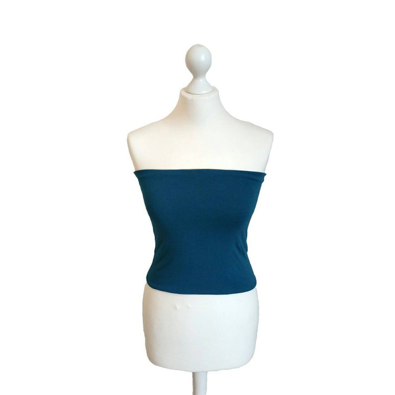 Blue strapless top on a white mannequin against a white background