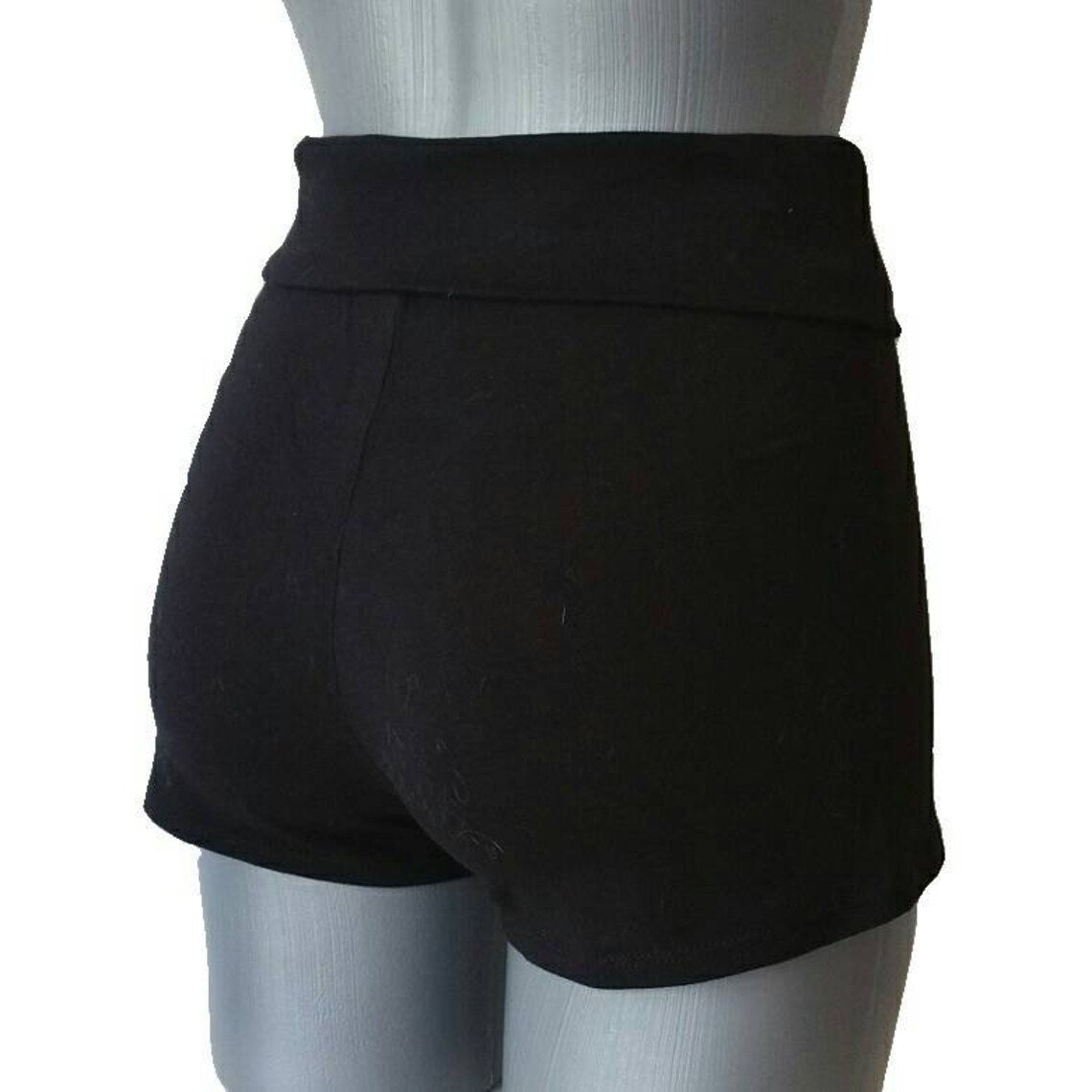 Black apron on a mannequin against a white background