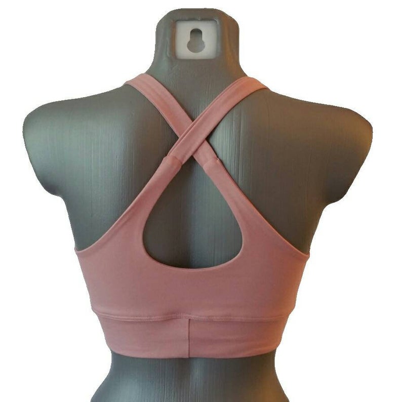 Pink sports bra on a mannequin with a white background