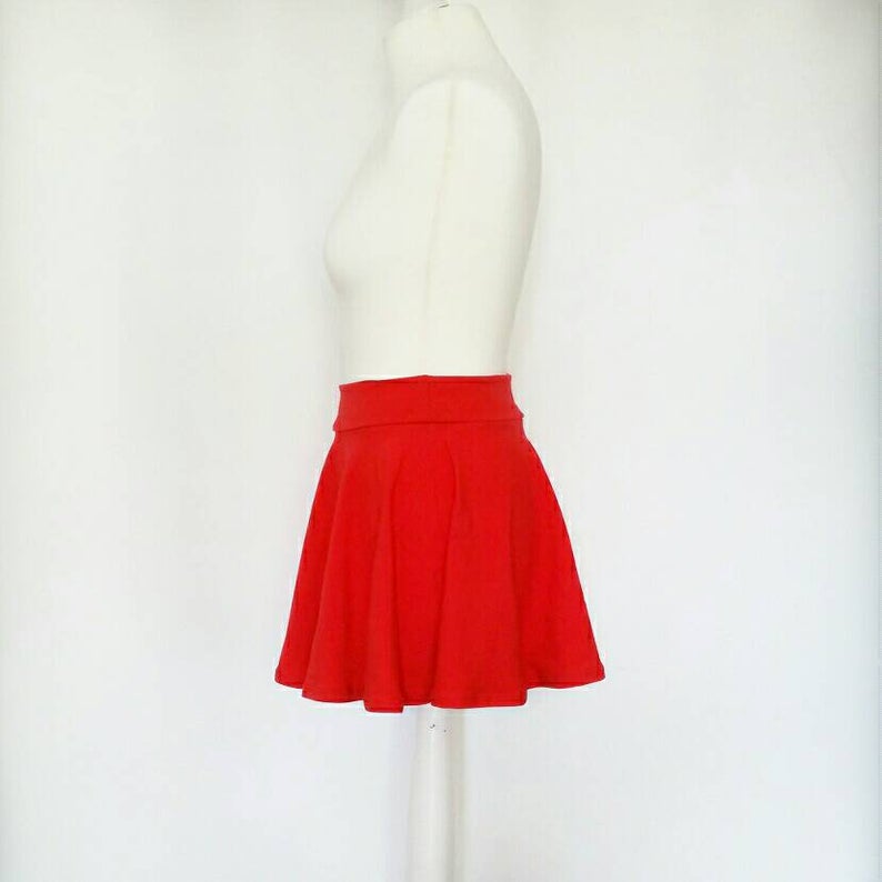 Red skirt on a mannequin against a white background