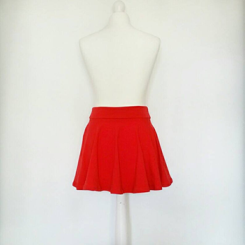 Red skirt on a mannequin against a white background