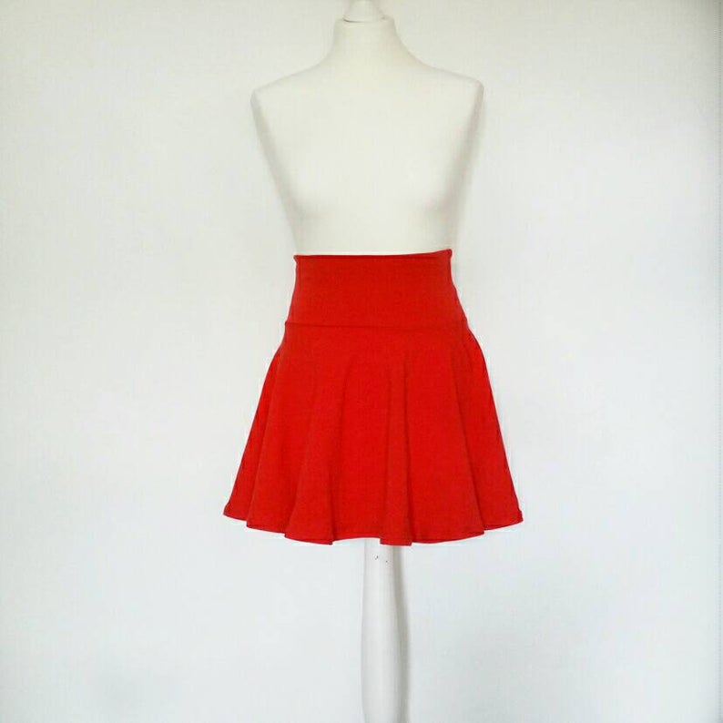 Red skirt on a mannequin against a white background