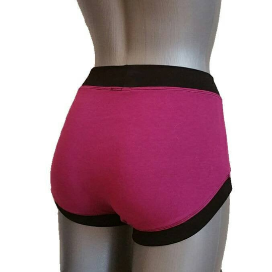 Violet athletic shorts with black waistband on a mannequin against a white background