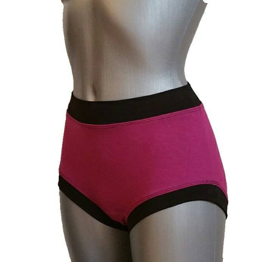 Pink high-waisted underwear with black waistband on a mannequin against a white background