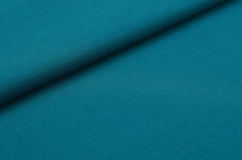 Teal fabric texture with a diagonal fold