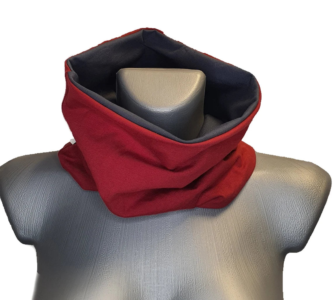 Red and navy scarf on a mannequin with a white background