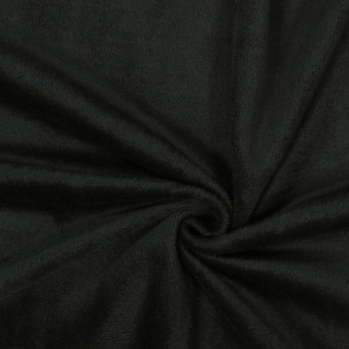 Fly and Fit black Alpine fleece core warmer fabric texture showing plush thermal material for winter training
