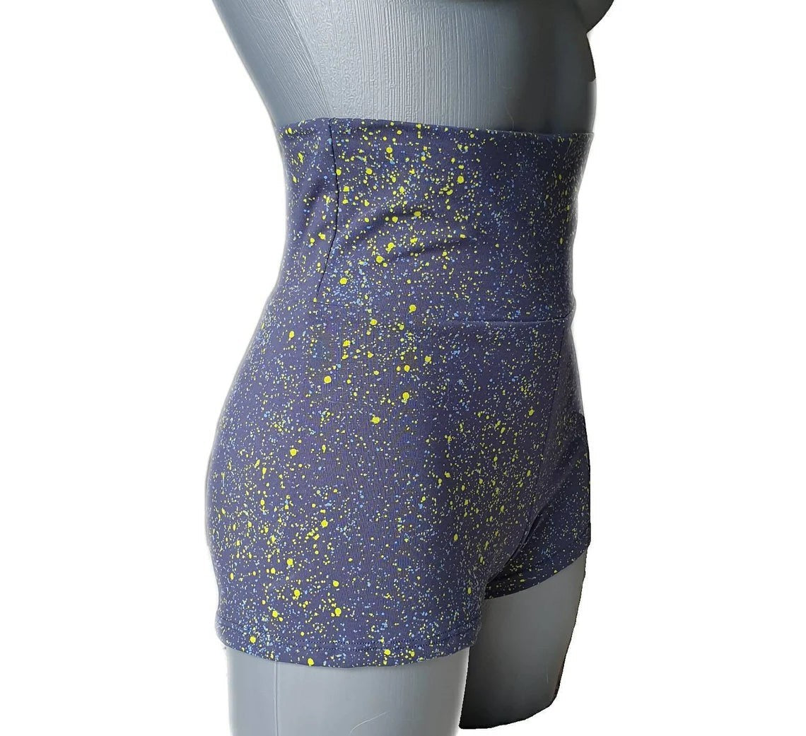 Fly and Fit blue cotton shorts with neon yellow paint splatter, high-waisted design for aerial fitness and yoga.