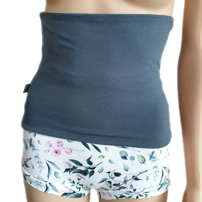 Fly and Fit reversible charcoal grey cotton jersey core warmer worn over floral print shorts for back support
