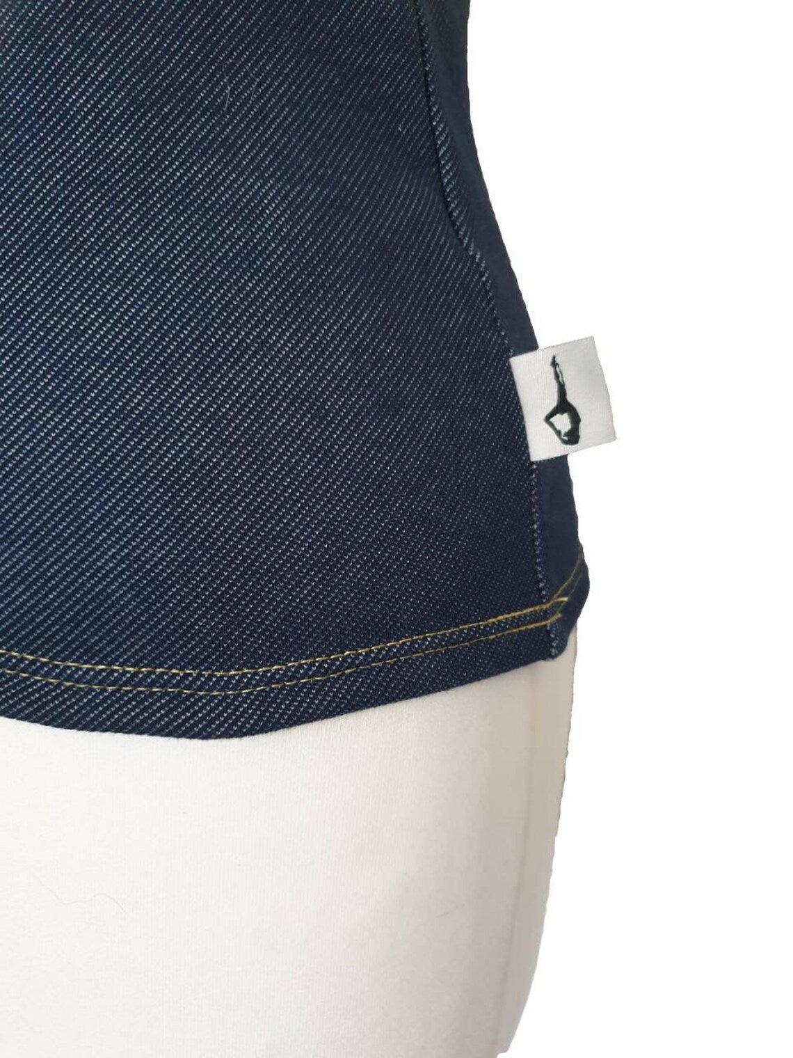 Fly and Fit Alpine Fleece Core Warmer in dark blue with a textured denim-look finish and a small brand logo tag.