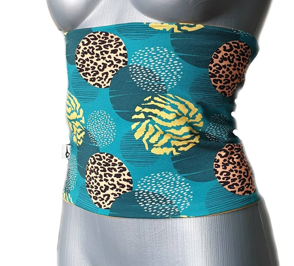 Fly and Fit reversible core warmer in petrol teal with floral leopard print on a mannequin torso.