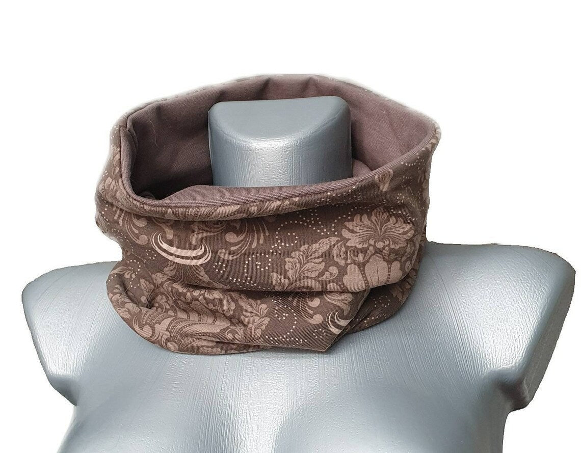 Fly and Fit reversible mocha brown cotton jersey back warmer with an elegant ornament print on a mannequin