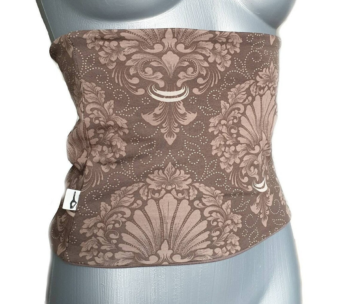 Fly and Fit reversible cotton jersey back warmer in mocha brown with an elegant ornament print on a mannequin torso.