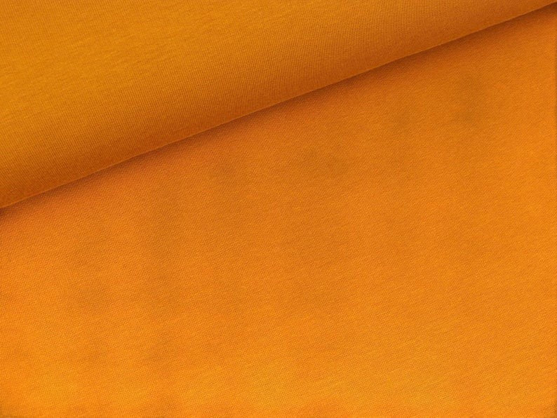 Fly and Fit orange cotton sweat haramaki wrap for core warmth and recovery. Lightweight, stretchy, and stays put.