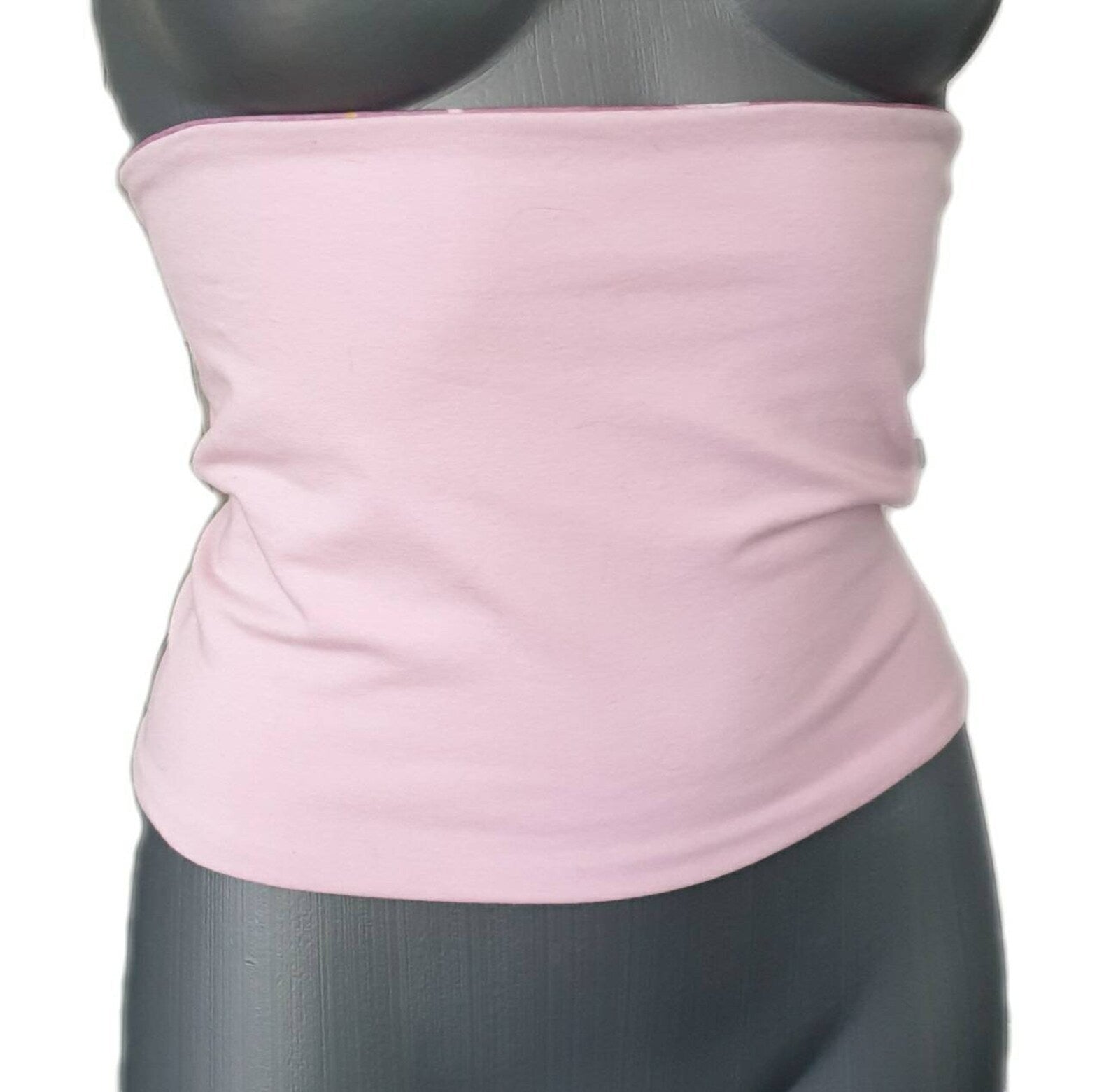 Fly and Fit reversible cotton jersey back warmer in solid baby pink worn on a mannequin
