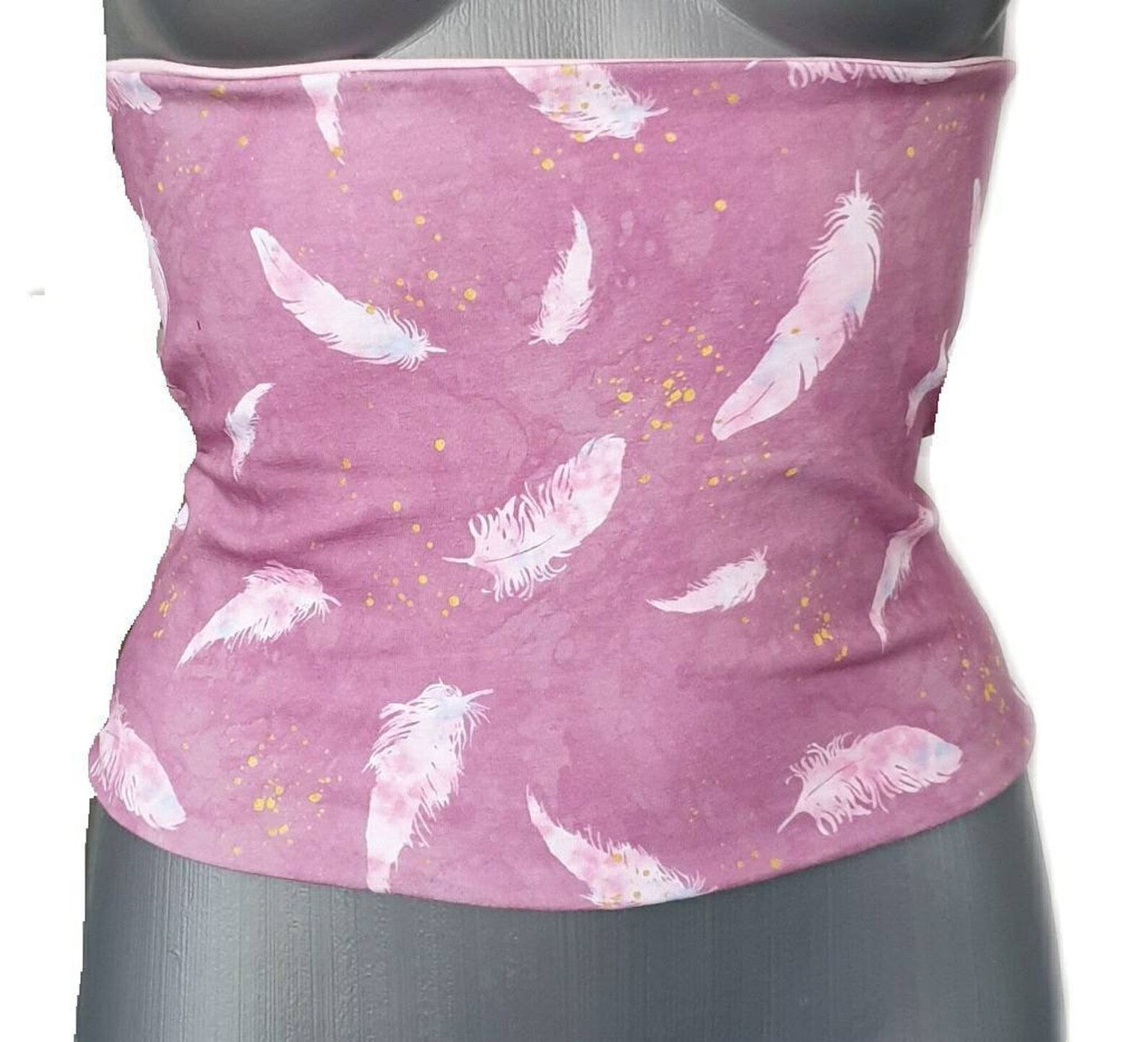 Fly and Fit reversible cotton jersey back warmer in pink with a delicate feather print on a mannequin torso.