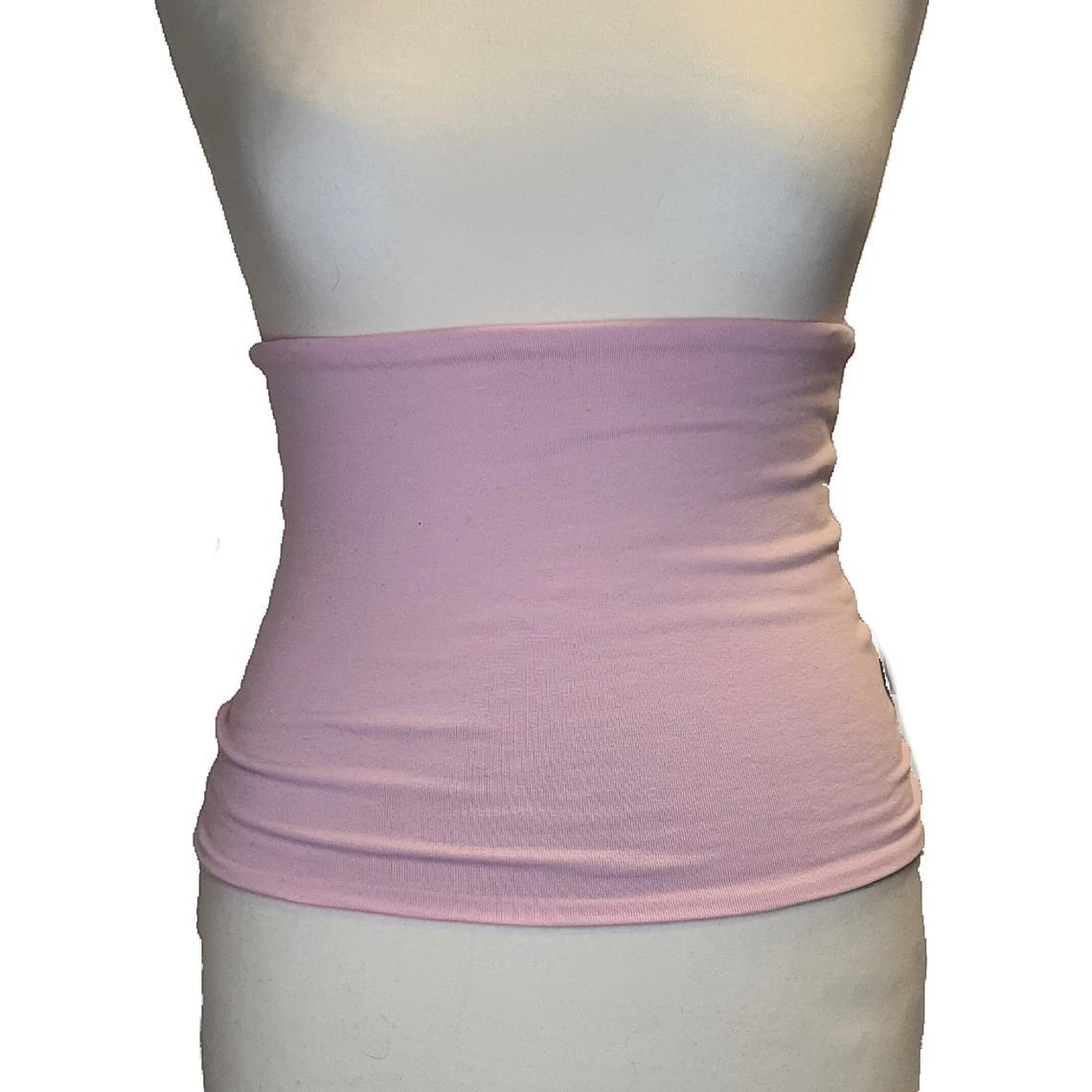 Fly and Fit soft pink reversible haramaki back warmer on a mannequin for balletcore and studio recovery.