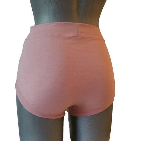 Fly and Fit powder pink cotton shorts with a seamless, no-elastic waistband and leg openings, ideal for lounge or active wear.