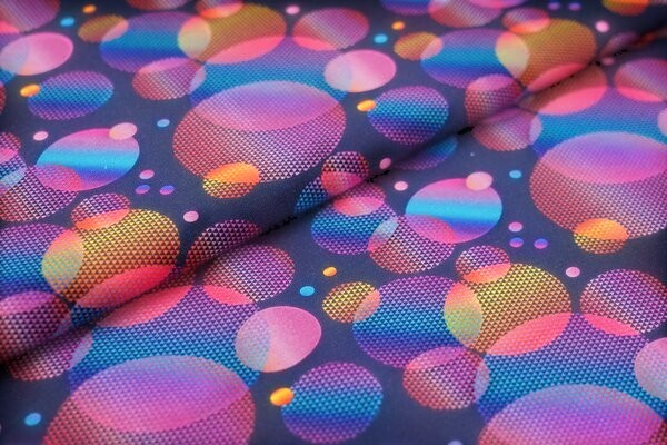 Fly and Fit Psychedelic Bubbles cotton fabric with vibrant overlapping pink, blue, and orange gradient circles.