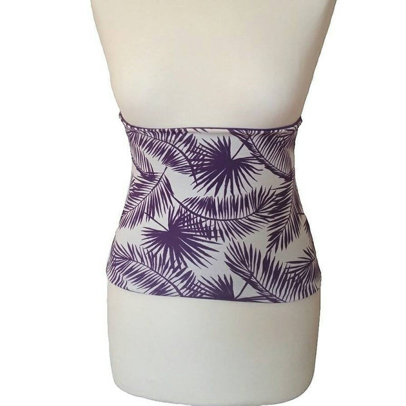 Fly and Fit reversible core warmer with a purple tropical leaf print on a white cotton jersey background.
