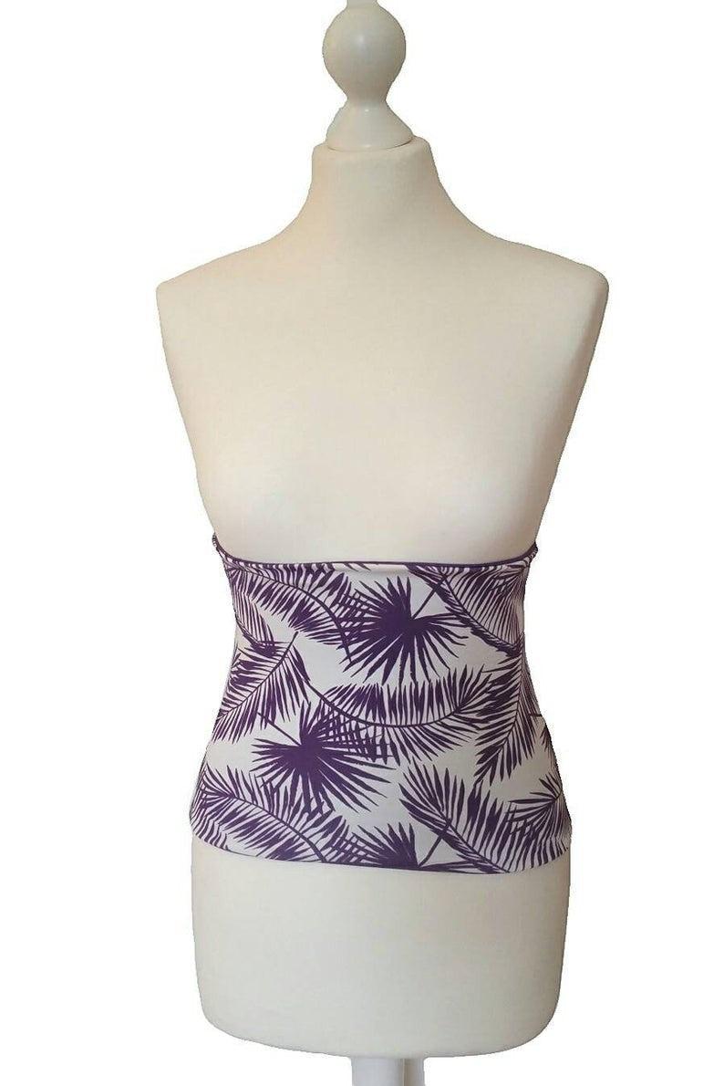 Fly and Fit reversible core warmer with a purple tropical leaf print on white cotton jersey fabric on a mannequin.