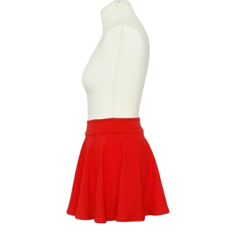 Fly and Fit red cotton skater skirt with a comfortable elastic-free waistband on a mannequin, side view