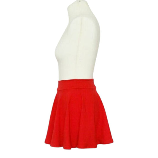 Fly and Fit red cotton skater skirt with a comfortable elastic-free waistband on a mannequin, side view
