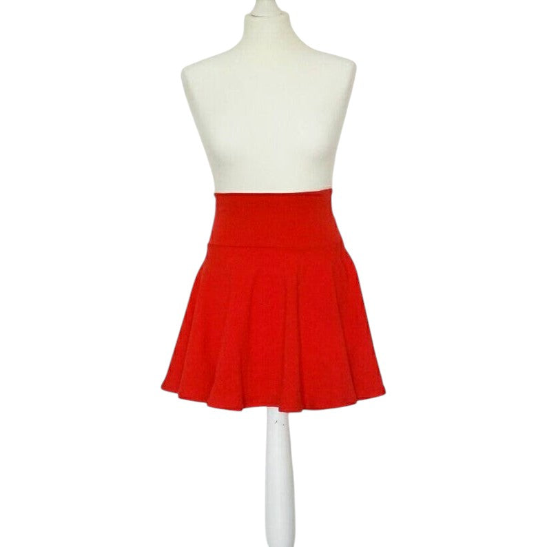 Fly and Fit red cotton skater skirt with a high-waisted, elastic-free design on a white mannequin display.