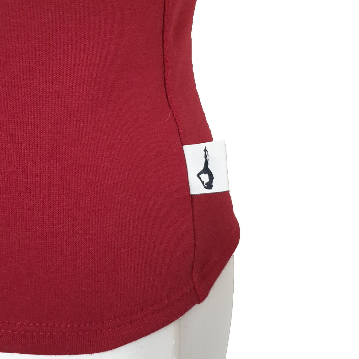 Fly and Fit red Alpine fleece core warmer with a small aerialist logo tag, designed for thermal core protection.
