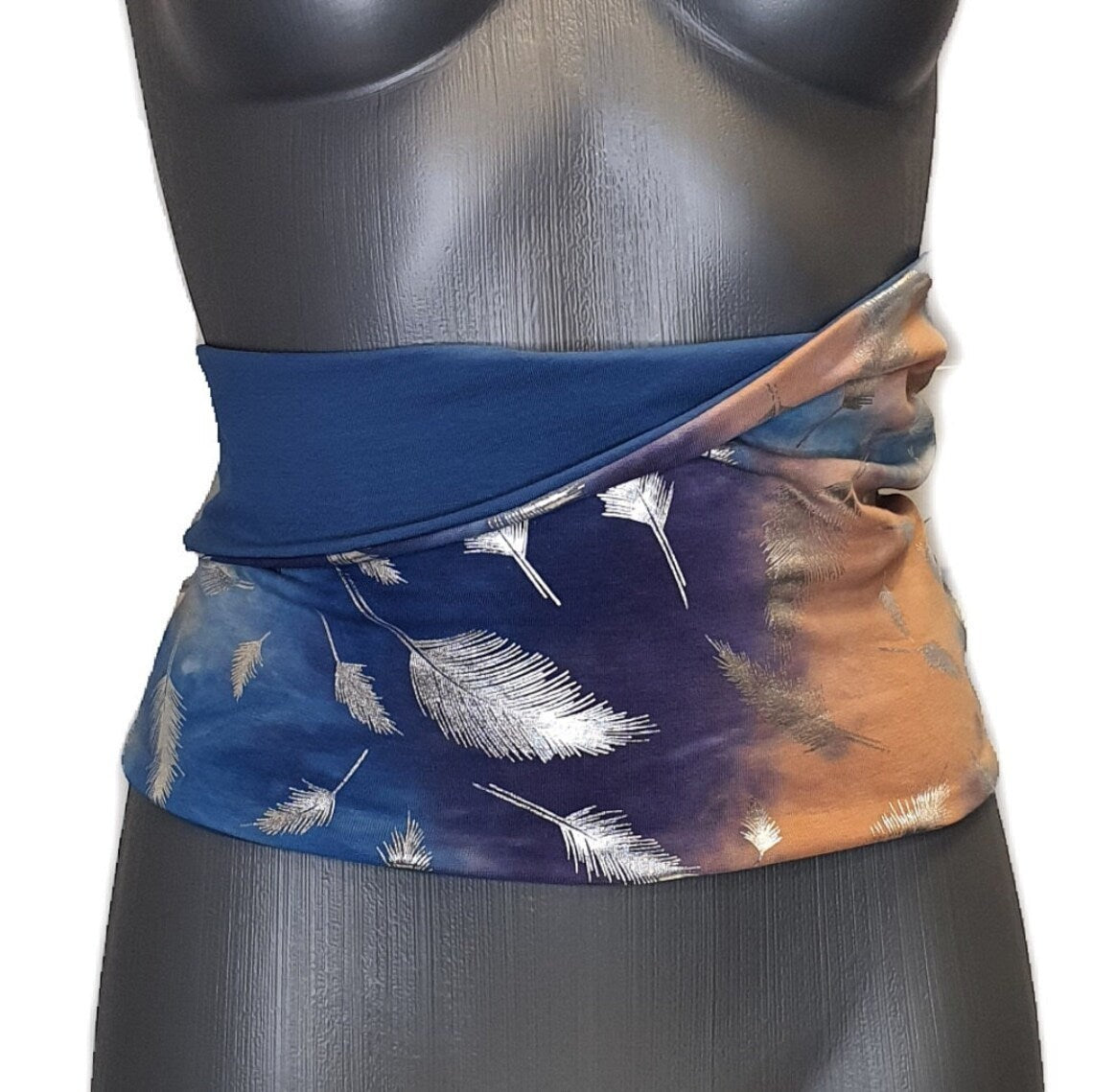Fly and Fit reversible cotton jersey haramaki back warmer with blue tie-dye and silver feather print on a mannequin.