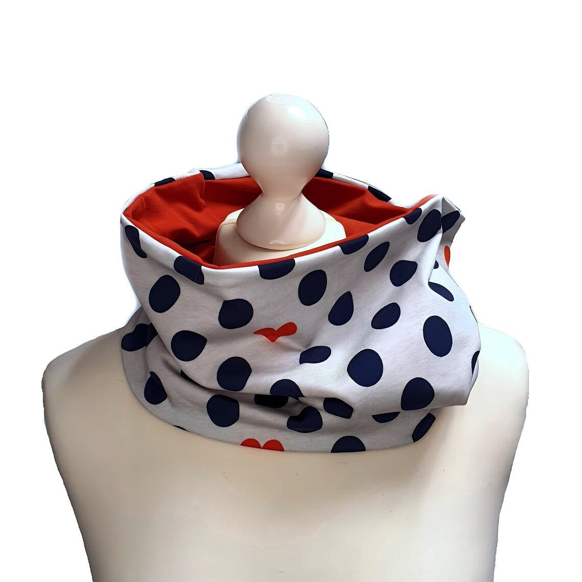 Fly and Fit reversible cotton jersey back warmer with navy polka dots, red hearts, and a solid red interior.