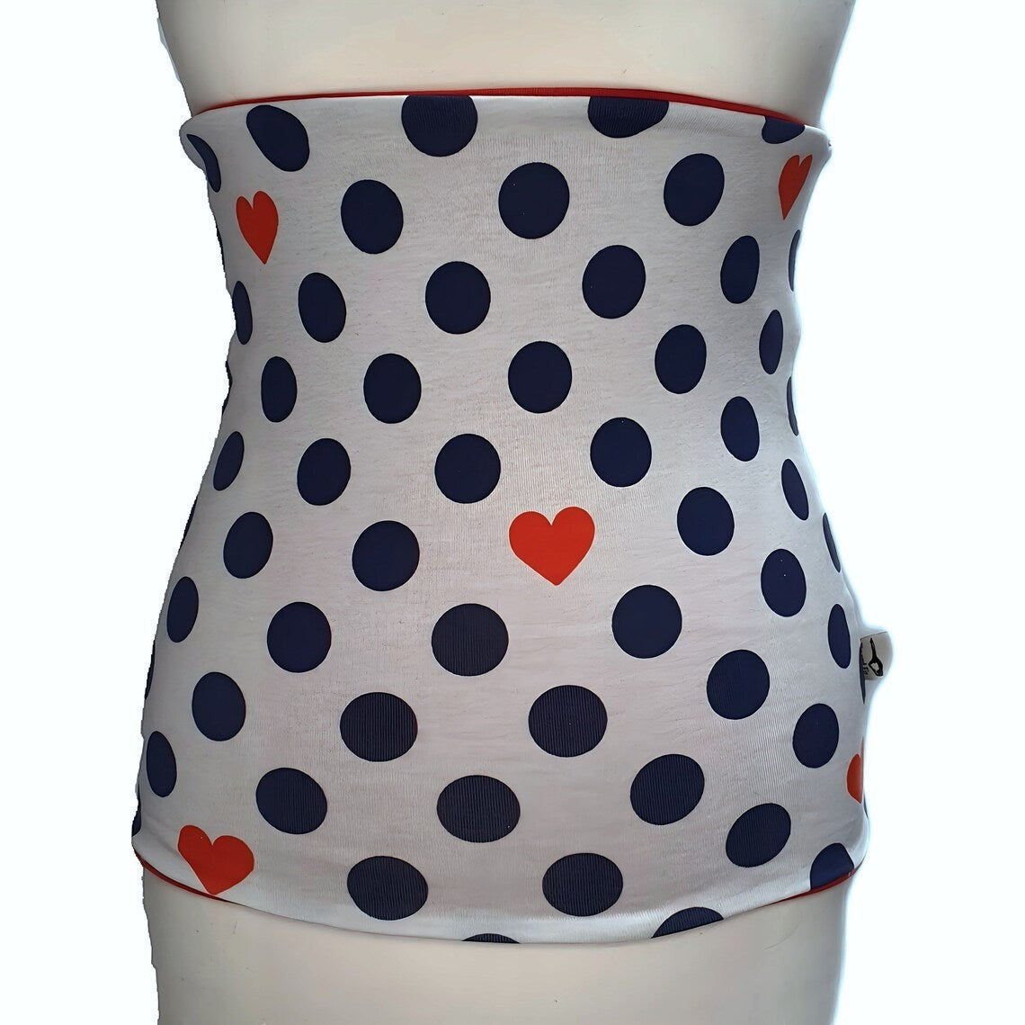 Fly and Fit reversible cotton jersey back warmer with white, navy blue polka dot, and red heart print on a mannequin