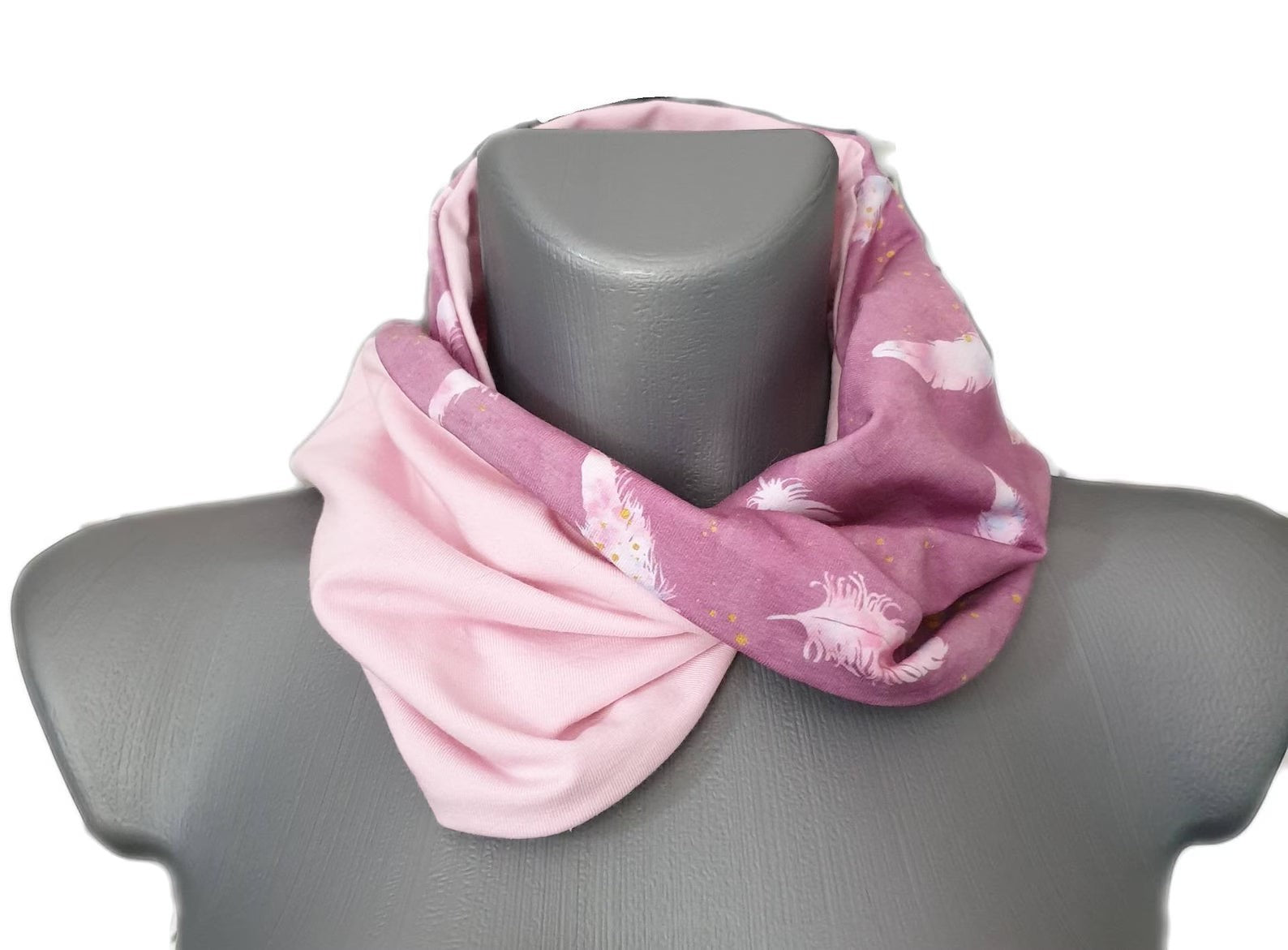 Fly and Fit reversible cotton jersey haramaki back warmer in pink with a delicate feather print and solid baby pink.