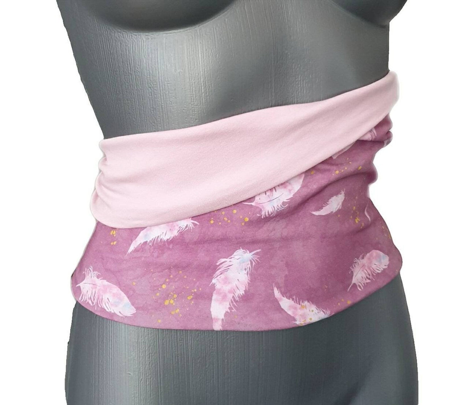 Fly and Fit reversible cotton jersey back warmer in pink with a delicate feather print and solid baby pink side.